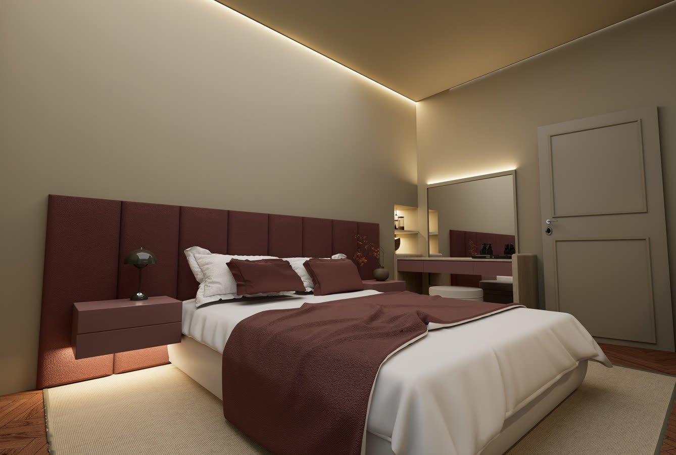 Camera con testiera imbottita bordeaux e luce a soffitto nascosta